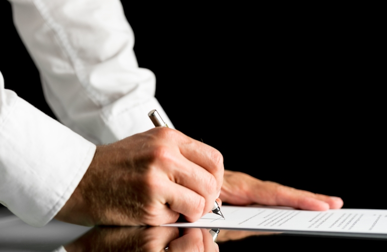 doctor signs the documents